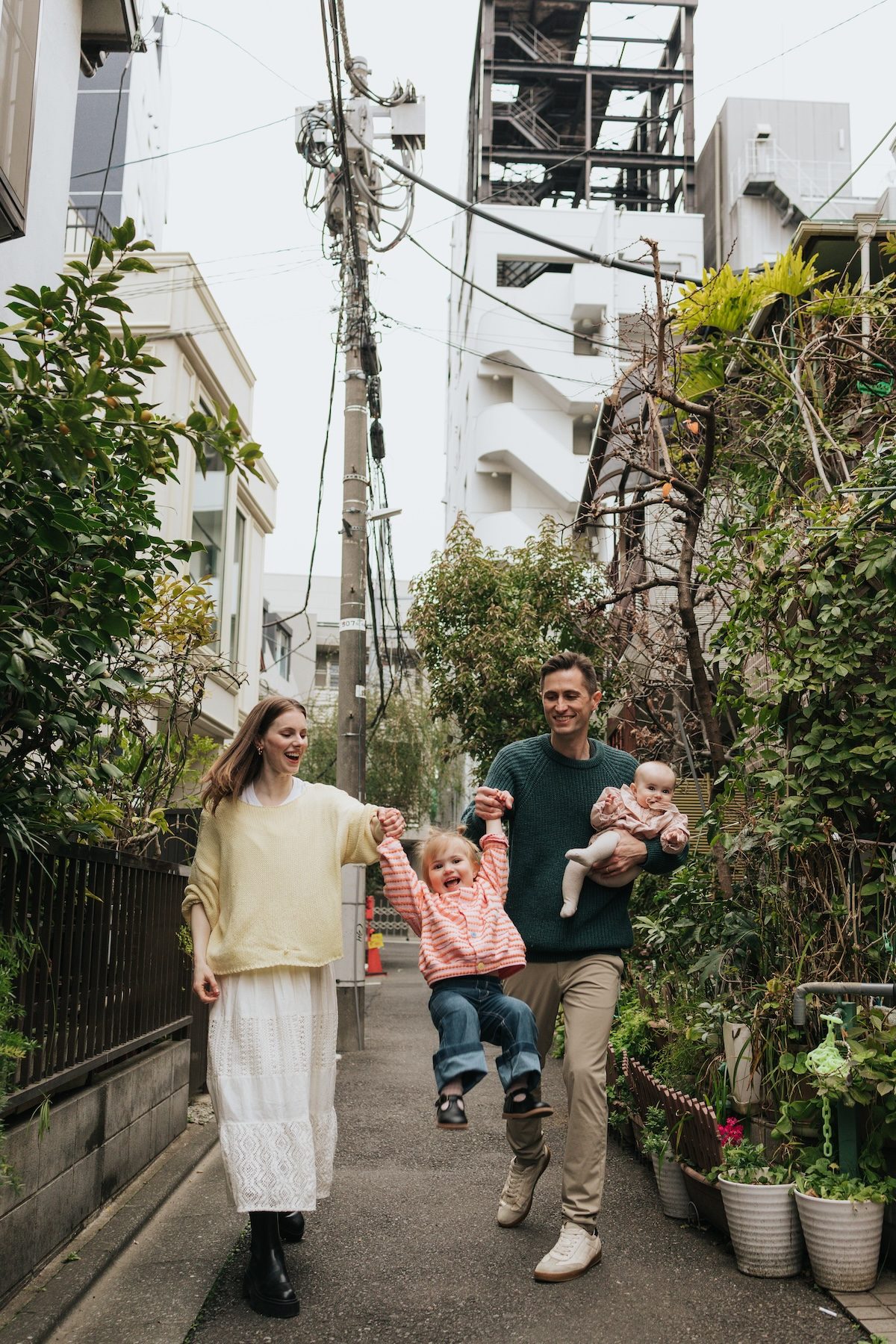 Kyle, Elise, Yuna, and Juni walking in a Tokyo neighborhood